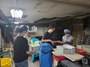 Community Archives Team searching archives in basement of Eubie Blake Cultural Center.