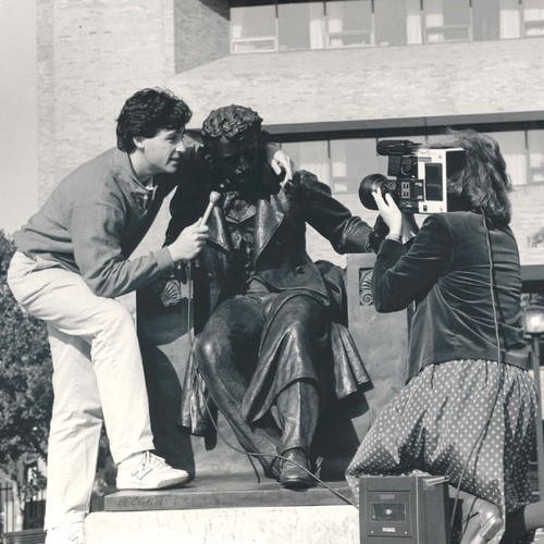 Poe statue on Gordon Plaza being "interviewed" by UBalt reporters.