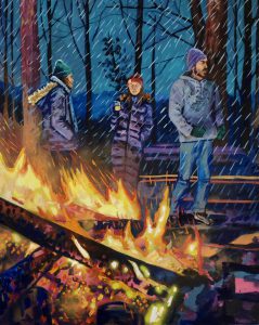 3 people stand near a lit bonfire in the rain