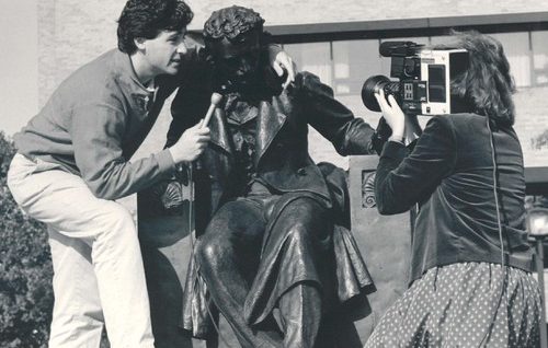 Poe statue on Gordon Plaza being "interviewed" by UBalt reporters.