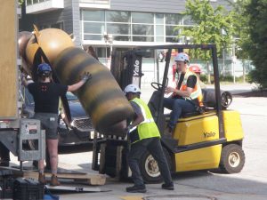 Workers unloading Bee Sculpture